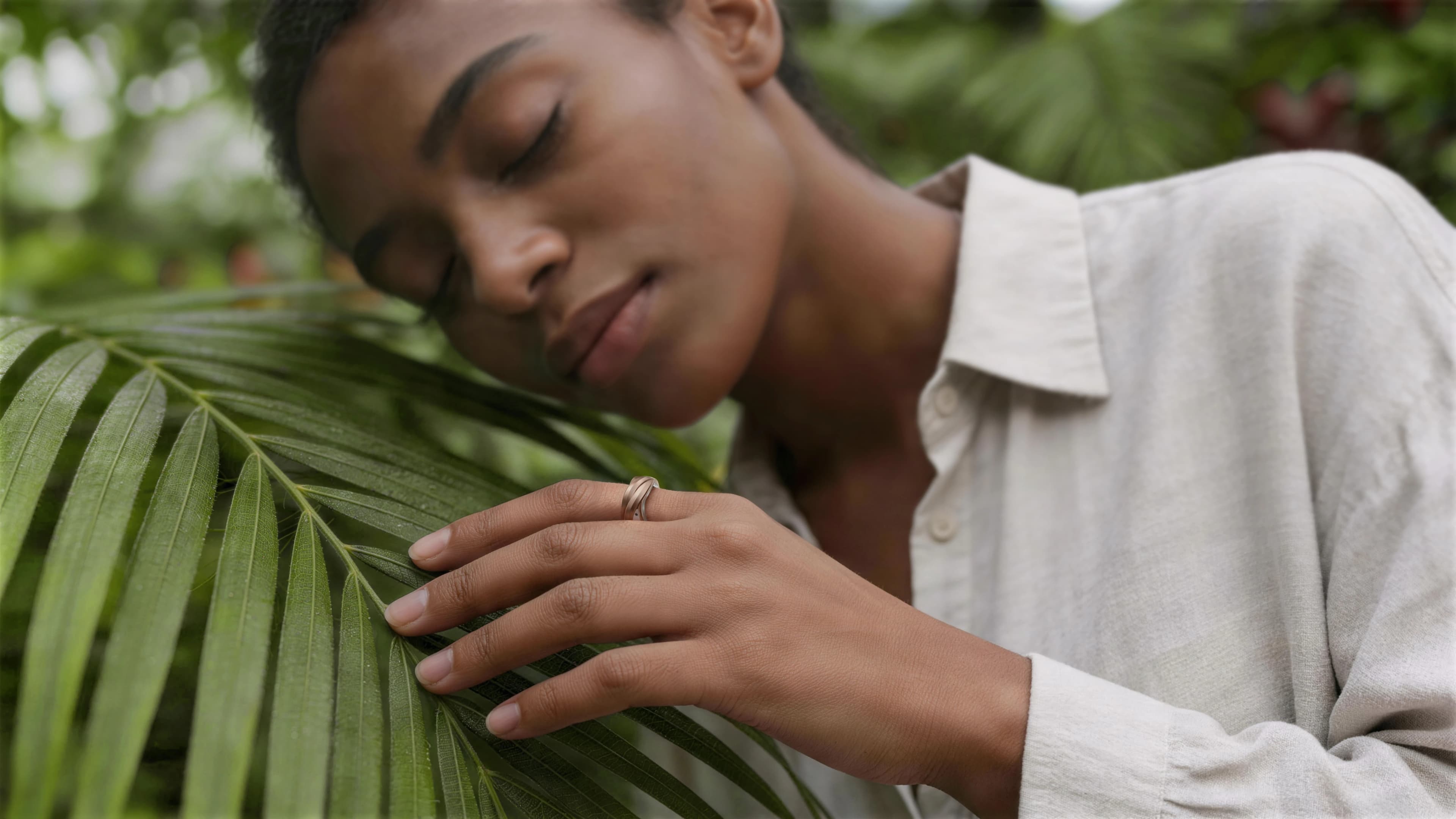 Glorify Ring worn in a quiet moment among palm leaves