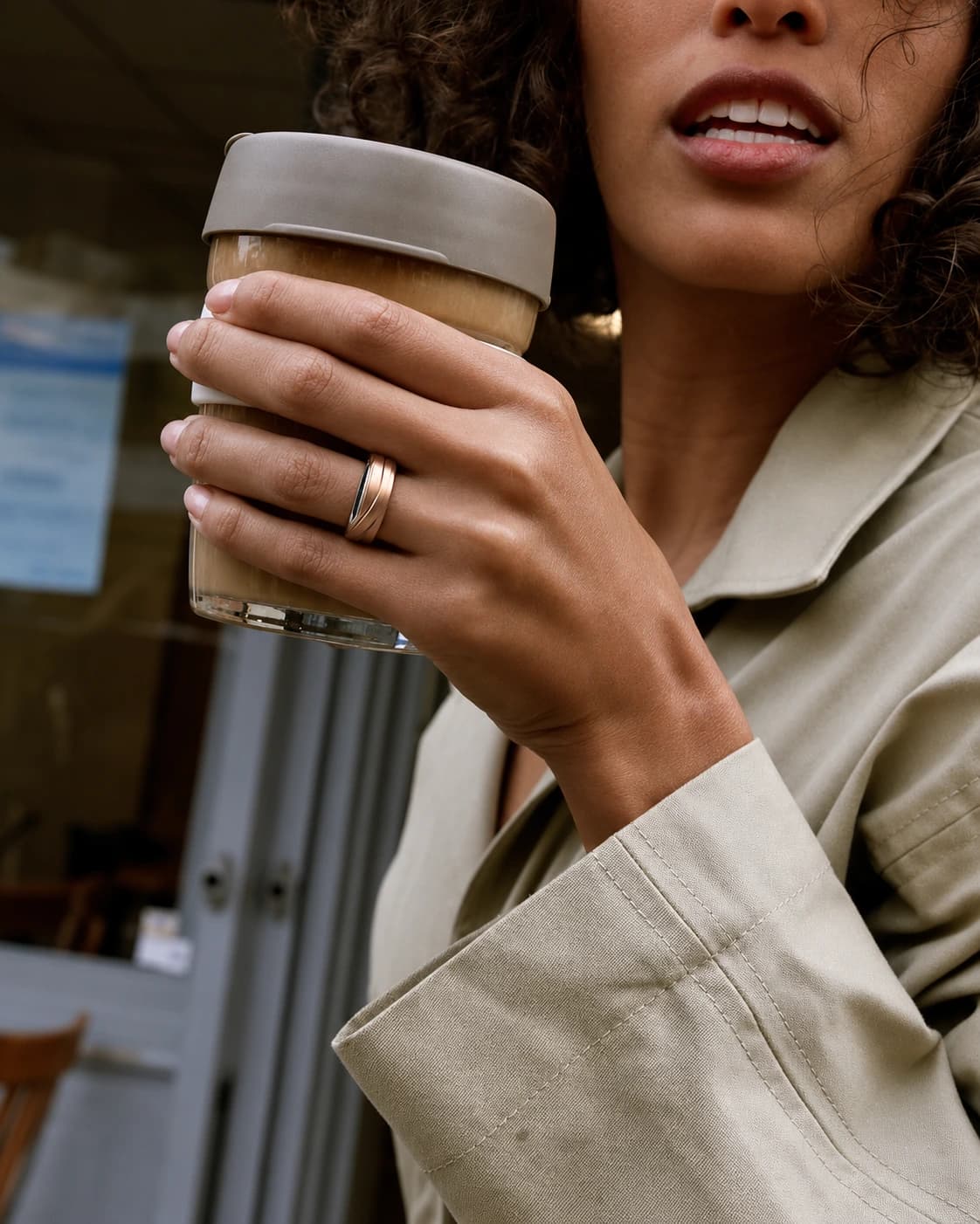 Person wearing Glorify Ring while holding a coffee cup